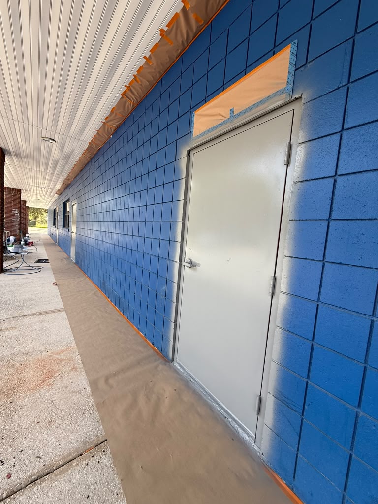All Saints Academy blue exterior with white door