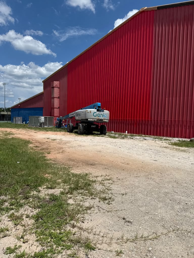 All Saints Academy red metal building exterior
