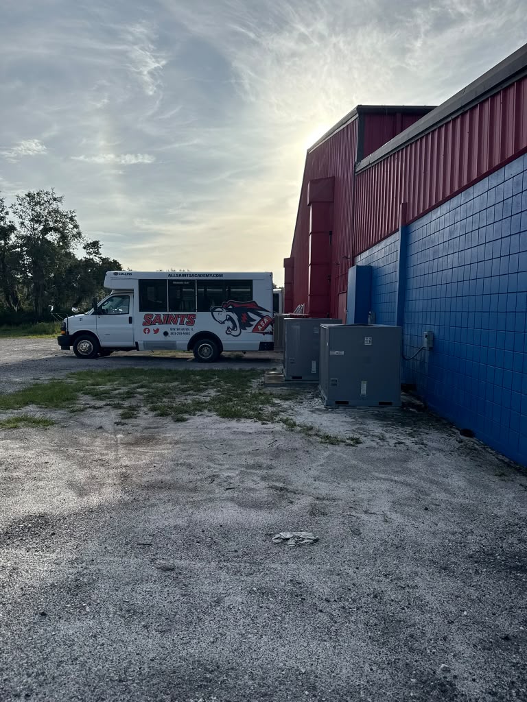 Commercial facility exterior with crew vehicle on-site