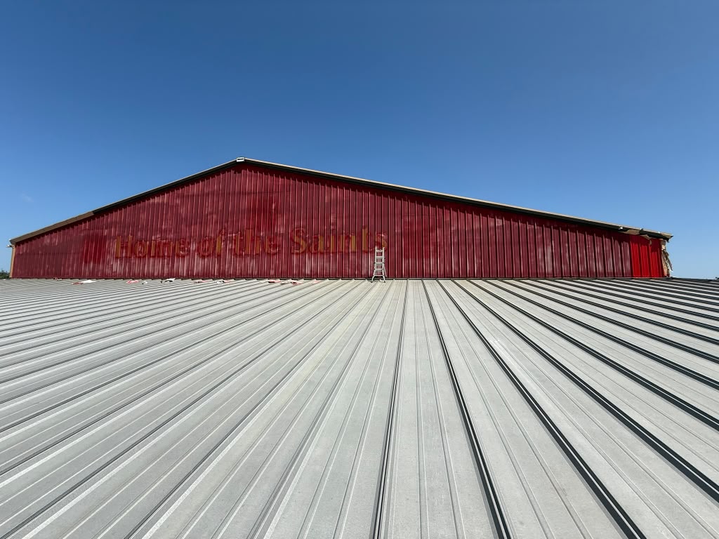 All Saints Academy building exterior, freshly painted red metal siding
